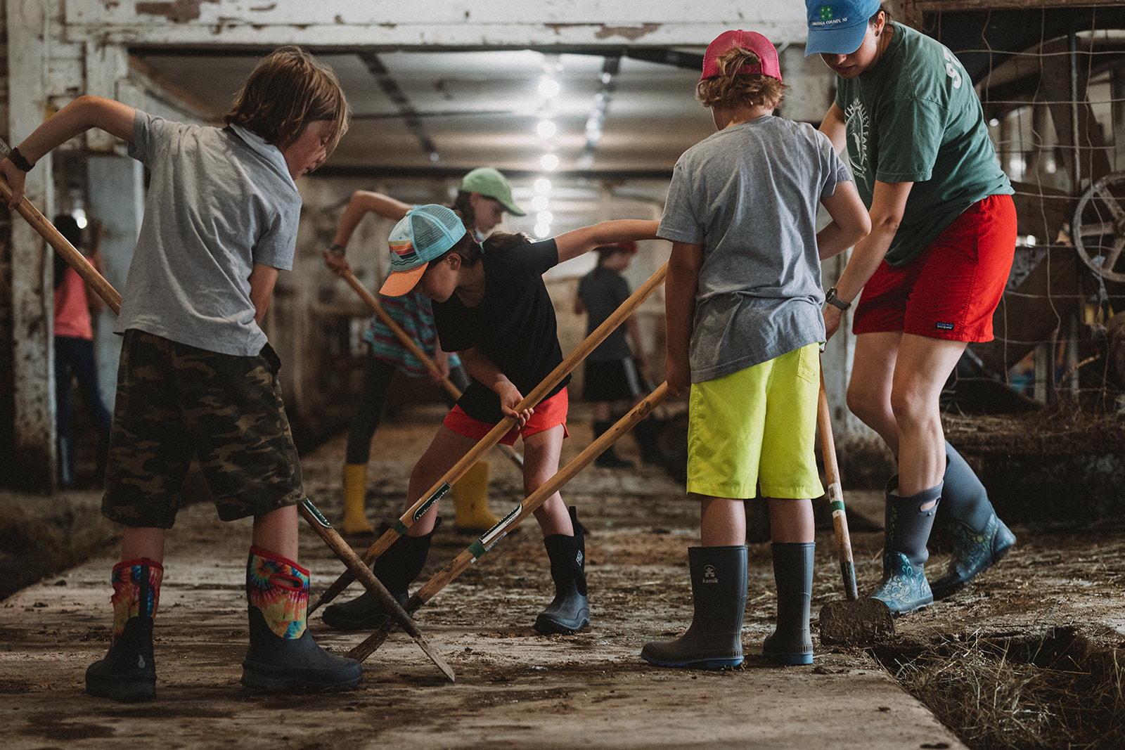 visiting students mucking the barn