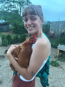 Hawthorne Valley Farm 2024 learner holding on of the farm's chickens